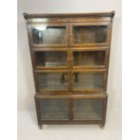 Mid century display case in four sections with glass doors on turned feet by Minty, approx 89cm x