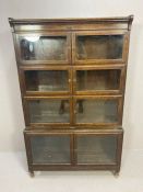 Mid century display case in four sections with glass doors on turned feet by Minty, approx 89cm x