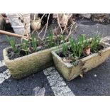 Two concrete garden troughs and their contents