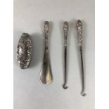 Collection of silver handled fully hallmarked items to include button hooks, nail buffer, and shoe