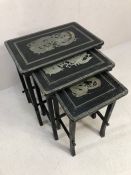 Set of black and silver ebonised wooden graduating tables, in a Chinese style, each depicting