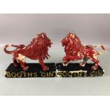 Pair of Booths Gin Red rampant lion advertising ceramic figurines each approx 15cm tall