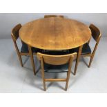 Mid century teak extending dining table by Nathan accompanied by four teak dining chairs with