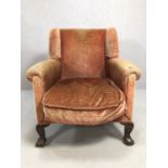 Antique wingback armchair on ball and claw feet