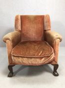 Antique wingback armchair on ball and claw feet