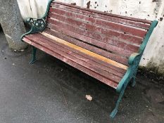 Wooden garden bench with green wrought iron bench ends, approx 126cm in length