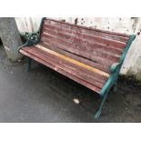 Wooden garden bench with green wrought iron bench ends, approx 126cm in length