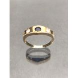 9ct Gold ring set with a blue sapphire in a star shaped mount with two Diamonds to either side