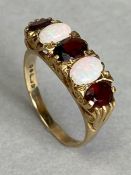 9ct Gold ring set with two Opals and three oval faceted red gemstones size approx 'P'