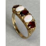 9ct Gold ring set with two Opals and three oval faceted red gemstones size approx 'P'