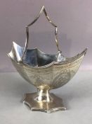 Silver Georgian hallmarked basket with swing handle made of eight panels each engraved with floral