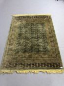 Oriental style green ground rug, approx 175cm x 123cm