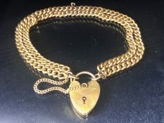 9ct Gold double strand curb link bracelet, links marked 9ct and 375 and a 9ct Gold heart shaped lock