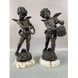 A pair of bronze cherubs each signed LG Moreau. One holding a tambourine and the other playing a