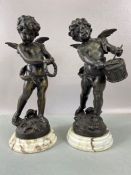 A pair of bronze cherubs each signed LG Moreau. One holding a tambourine and the other playing a