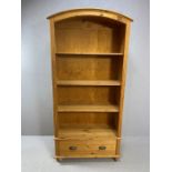 Pine bookcase with domed top, three shelves and cupboard under, approx 95cm x 39cm x 190cm tall