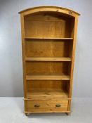 Pine bookcase with domed top, three shelves and cupboard under, approx 95cm x 39cm x 190cm tall