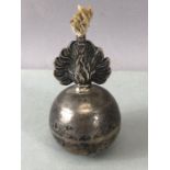 Silver hallmarked unusual spherical oil burning candle with silver flame effect from which the