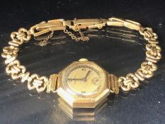 Wristwatch in 9ct Gold Octagonal case by VERTEX on a rolled gold strap total weight approx 15.6g