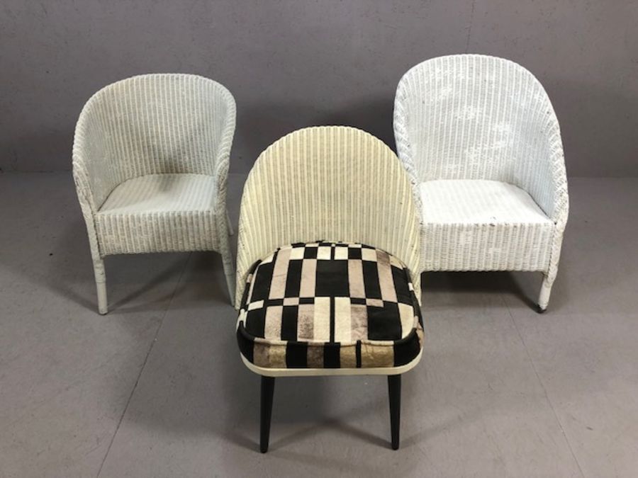 Three Lloyd Loom style chairs, including one retro-style on tapering legs