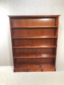Pine stained bookcase with four shelves, approx 130cm x 26cm x 160cm tall