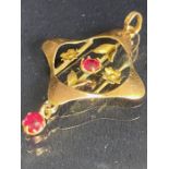 9ct Gold pendant in the Art Nouveau style with gold flowers and set with red gemstones