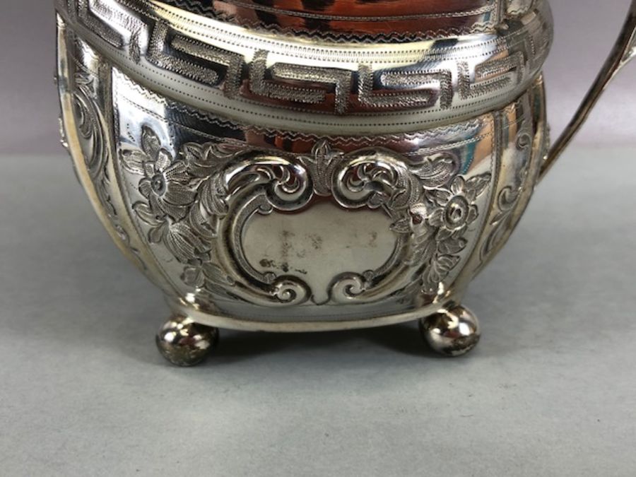 Silver hallmarked jug on four bun feet with gold gilt interior and repoussé floral decoration - Image 4 of 12