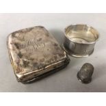 Silver items to include cigarette case (A/F) thimble and a napkin ring (80g)