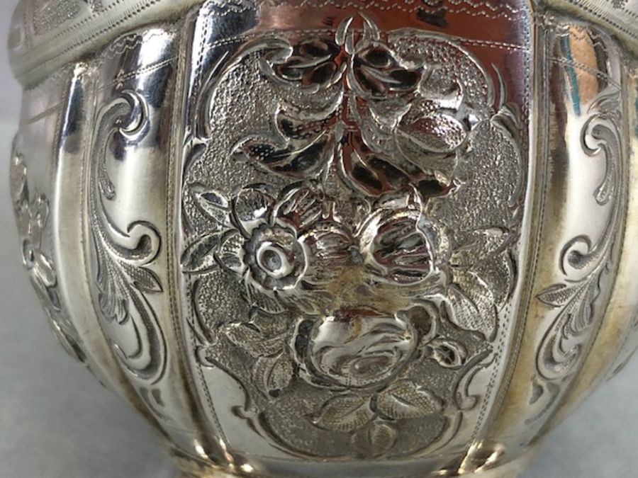 Silver hallmarked jug on four bun feet with gold gilt interior and repoussé floral decoration - Image 6 of 12