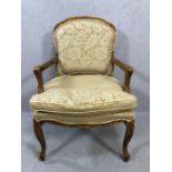 Walnut framed modern occasional chair with carved arms and legs floral design on arms and back