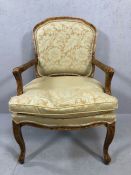 Walnut framed modern occasional chair with carved arms and legs floral design on arms and back