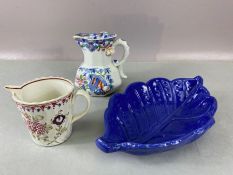 Collection of three ceramic items: two early jugs (one Mason's) and a blue leaf-design dish, largest