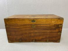 Camphor wood chest in a campaign style with brass fittings and metal carry handles, approx 102cm x