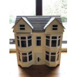 Large wooden hand-made dolls house with good collection of furniture, approx 55cm wide x 35cm deep x