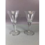 Pair of large handblown wine glasses with tear drop bubble in the stem on large circular bases