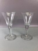 Pair of large handblown wine glasses with tear drop bubble in the stem on large circular bases