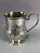 Hallmarked Silver Tankard with floral repousse design approx 9.5cm tall &147g hallmarked for