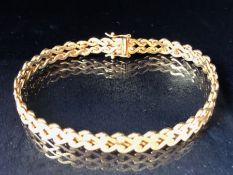 9ct Gold bracelet with curved interlocking links and good quality fastener with two safety catches