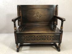 Oak monks bench with flip over seat back, hinge lid to storage under and carved detailing, approx 91