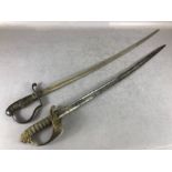 Two Officers swords one with Brass hilt with lion quillon both with engraved blades (2)