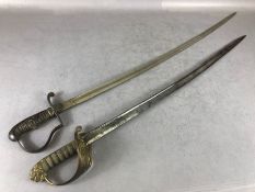 Two Officers swords one with Brass hilt with lion quillon both with engraved blades (2)