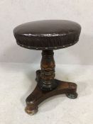 Antique piano stool on carved pedestal with leather seat pad