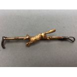 9ct Gold and silver hunting brooch depicting a fox and a riding crop approx 6cm long and 2.8g