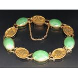 Chinese Gold coloured Bracelet with Oval links alternately set with Chinese characters and Green