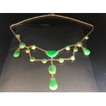 Gold coloured necklace in a Chinese style set with Green Gemstones makers mark stamped "LW20"