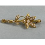 9ct Gold brooch set with seed pearls with a floral design approx 2g