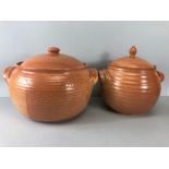 Two large ceramic lidded pots, the largest approx 32cm across