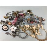 A collection of costume Jewellery to include broaches, pendants, bracelets, approximately 60