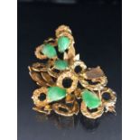 14ct Gold Brooch set with Green gemstones approx 5cm wide and 12.1g (one stone missing)