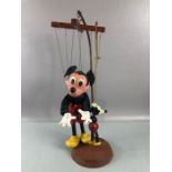 Two vintage Mickey Mouse puppets, the taller suspended on a stand approx 45cm in height